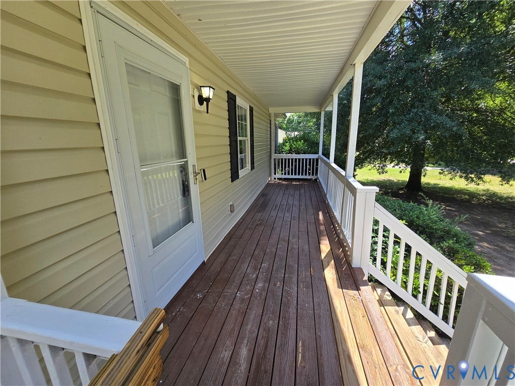 1019 Arizona Drive, Woodhaven, Richmond, VA 23224 Covered front porch with wood-finish decking, white railings, and a screen door entry