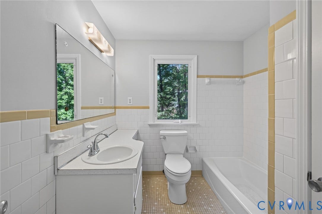 2317 Pleasant Run Drive, Henrico, VA 23238 Bathroom featuring a white vanity with an integrated sink, a rectangular mirror, and a white tiled shower with a tub