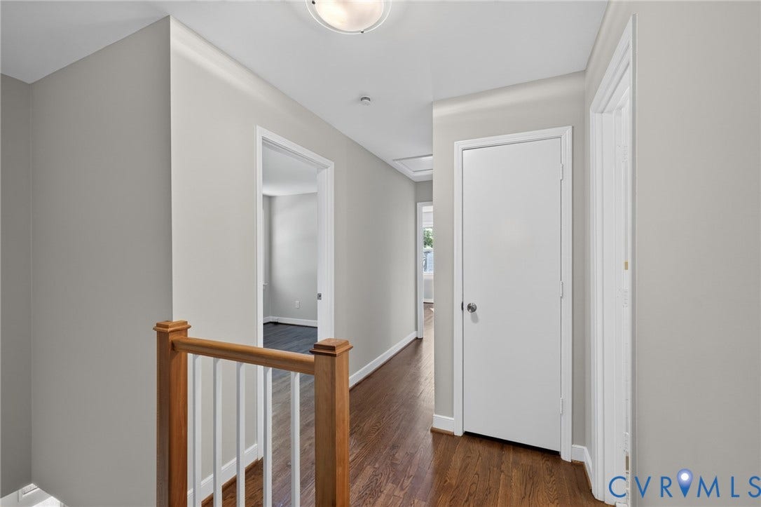 2317 Pleasant Run Drive, Henrico, VA 23238 Hardwood-finish flooring, light gray wall paint, crown molding, white doors, and a wood railing with white spindles
