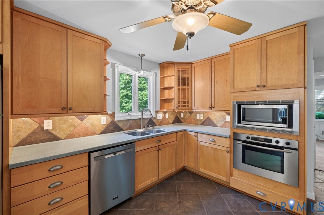 2317 Pleasant Run Drive, Henrico, VA 23238 Natural wood cabinetry, stainless steel appliances, tile flooring, window with natural light, and a ceiling fan with integrated lighting