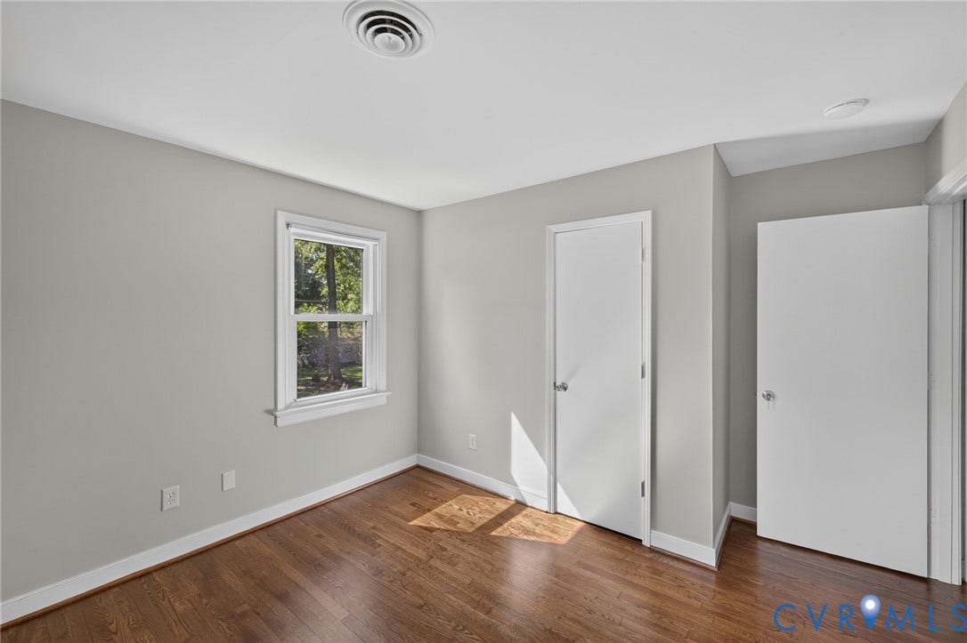 2317 Pleasant Run Drive, Henrico, VA 23238 Hardwood flooring with neutral wall paint, white trim, and a white interior door