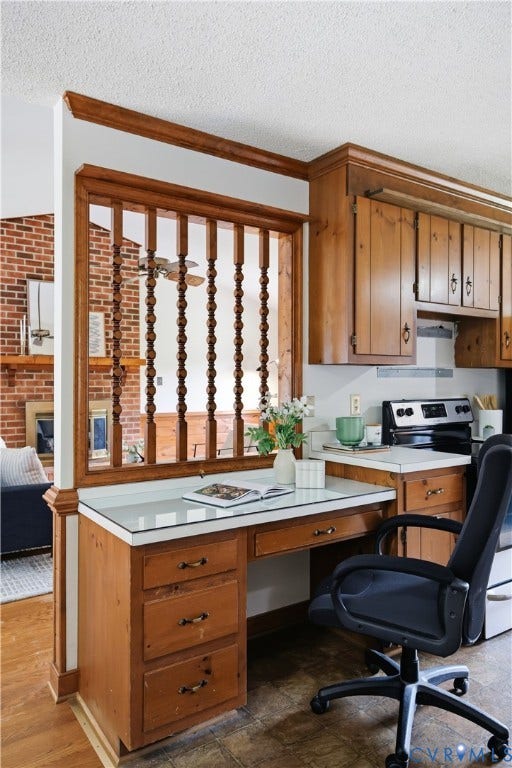3231 Ludgate Road, Chester, VA 23831 Built-in wood-finish desk with three drawers, adjacent to wood-finish cabinetry, featuring a white countertop and a white tile backsplash