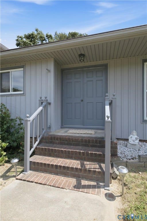 3231 Ludgate Road, Chester, VA 23831 Board and batten exterior with a double entry door and brick steps