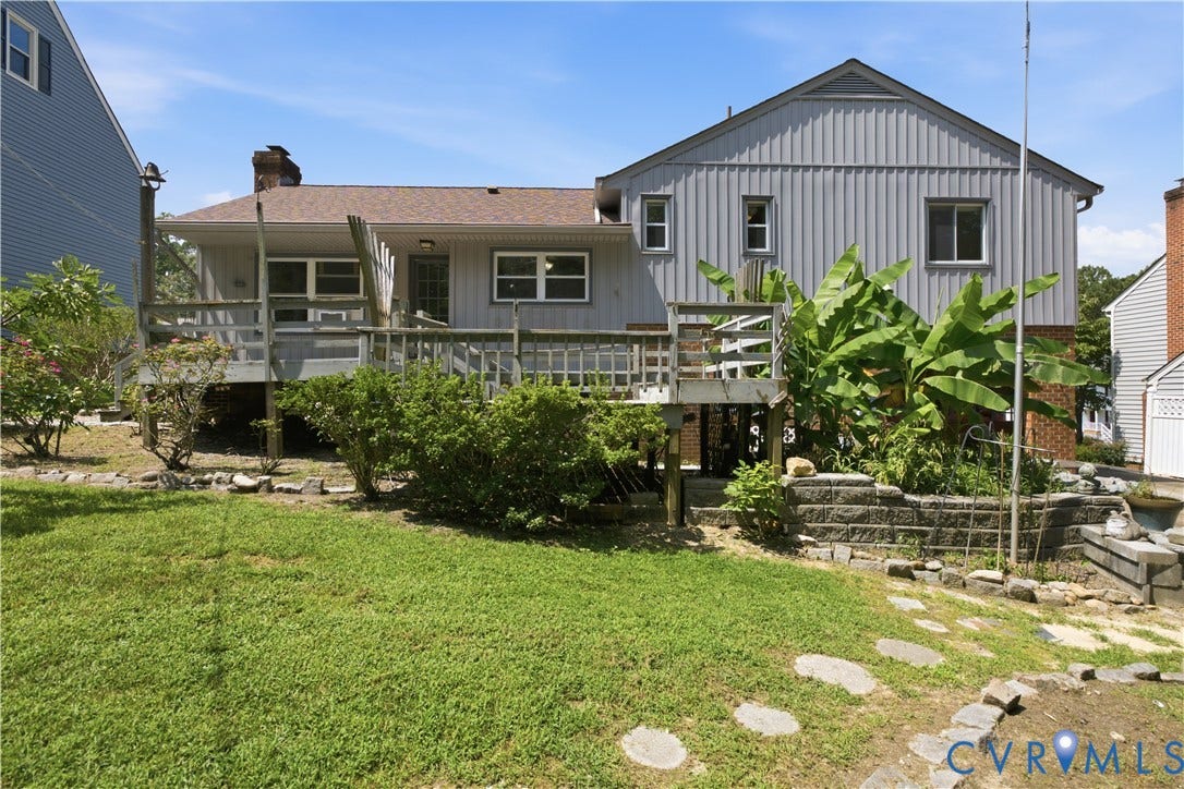 3231 Ludgate Road, Chester, VA 23831 Expansive multi-level wood deck, stone retaining walls, mature landscaping, and an exterior featuring vertical panel siding