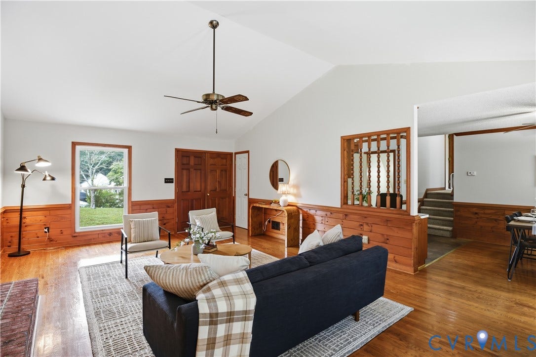 3231 Ludgate Road, Chester, VA 23831 Vaulted ceiling with a ceiling fan, wood-finish flooring, wood paneling, and an interior wood partition