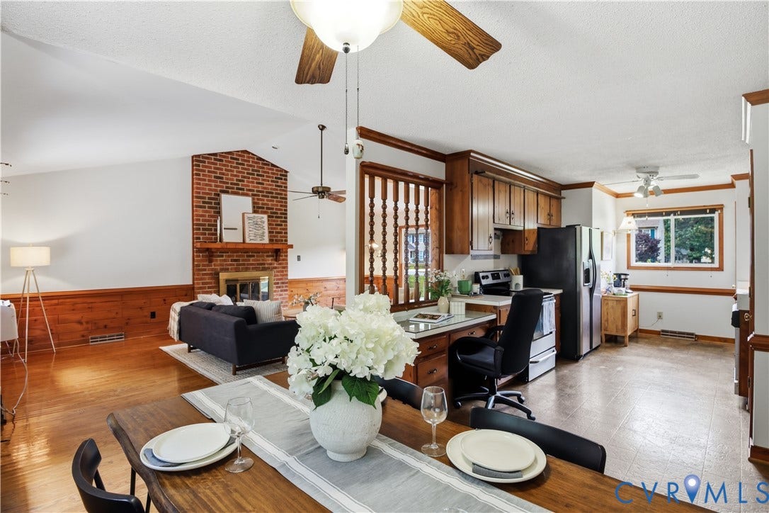 3231 Ludgate Road, Chester, VA 23831 Wood-finish flooring, brick fireplace, wood paneling, wood cabinetry, and ceiling fans