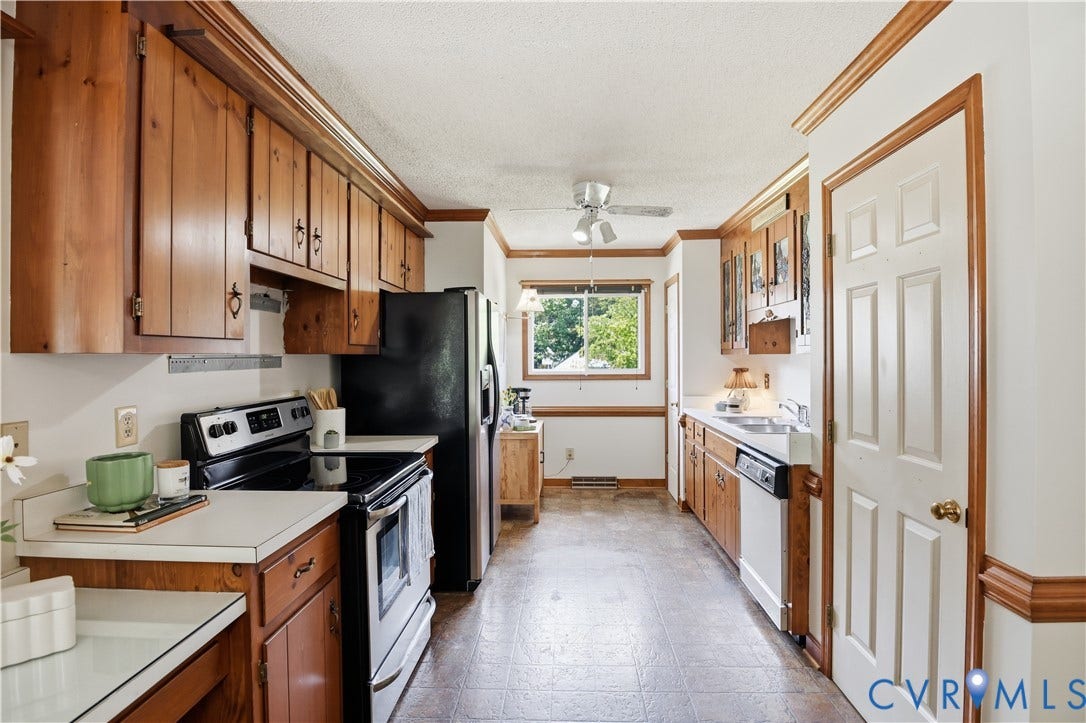 3231 Ludgate Road, Chester, VA 23831 Kitchen featuring wood cabinetry, white countertops, built-in stainless steel appliances, and a window over the sink