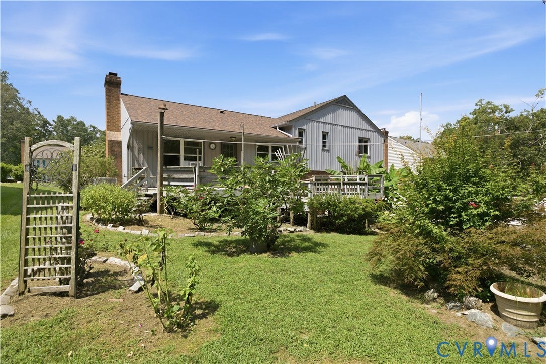 3231 Ludgate Road, Chester, VA 23831 Expansive rear yard featuring a multi-level wood deck, mature landscaping, and a brick chimney