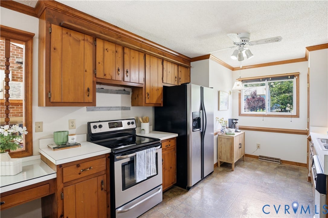 3231 Ludgate Road, Chester, VA 23831 Wood cabinetry with crown molding, stainless steel appliances, and a ceiling fan
