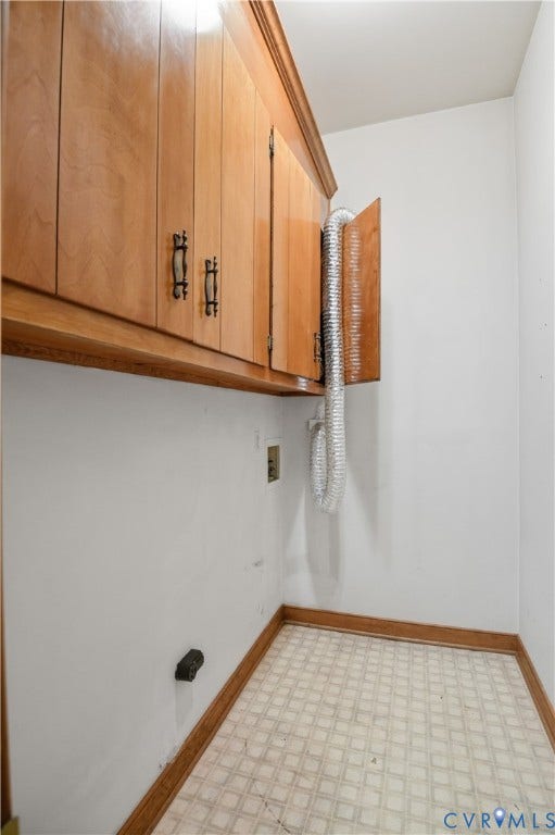 3231 Ludgate Road, Chester, VA 23831 Built-in wood cabinetry with decorative handles, white walls, and patterned tile flooring