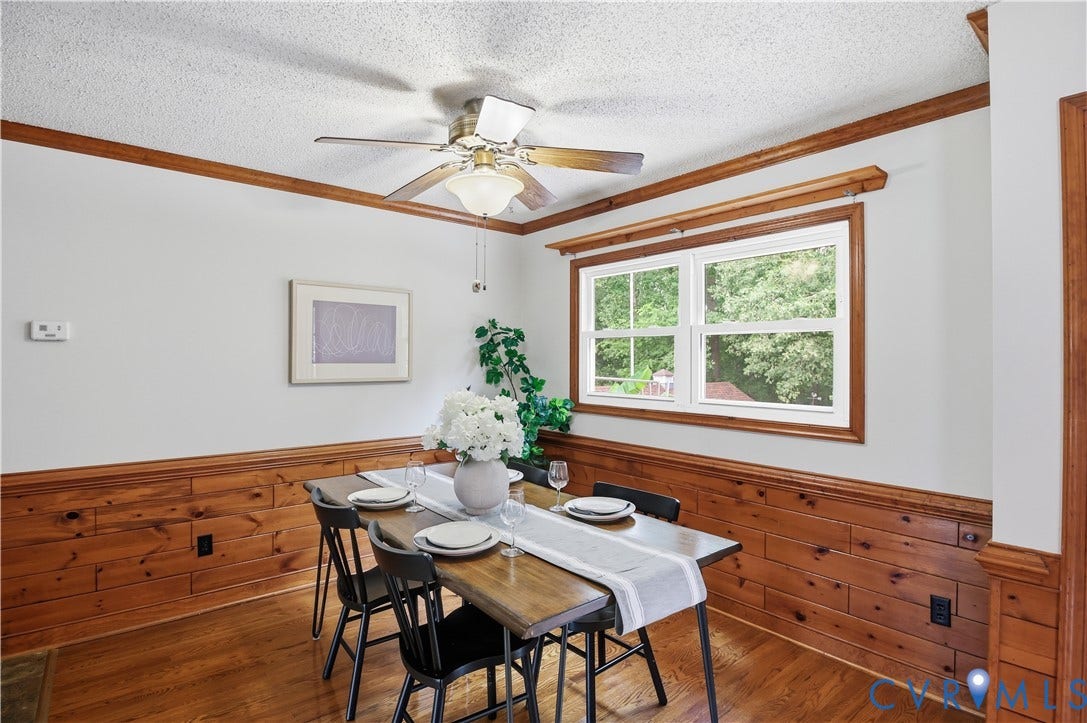 3231 Ludgate Road, Chester, VA 23831 Hardwood flooring, wood-paneled walls, wood trim, white window frames, and a ceiling fan with integrated lighting