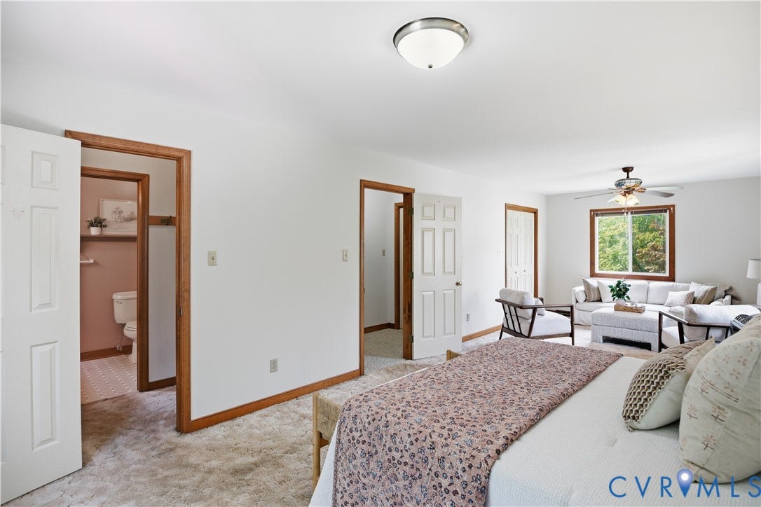 3231 Ludgate Road, Chester, VA 23831 Spacious room with light-colored carpeting, multiple doorways, and a window with wood trim