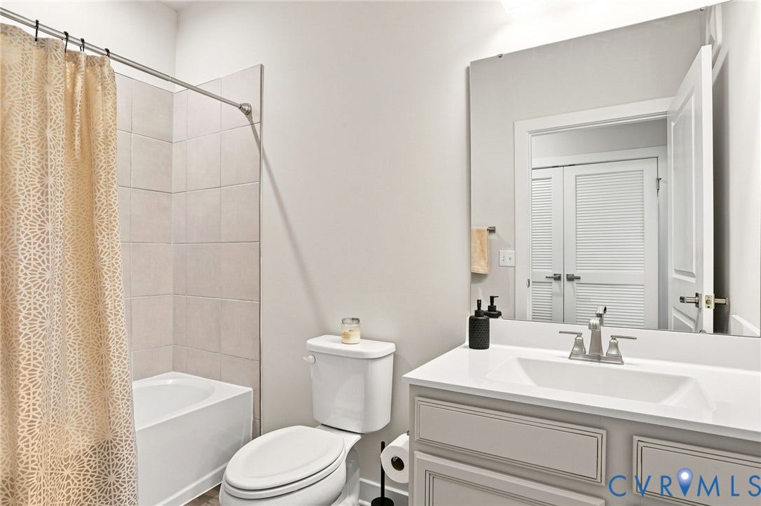 3900 Maze Runner Drive, #403, Midlothian, VA 23112 Bathroom featuring a single vanity with an integrated sink, brushed nickel faucet, and a large wall-mounted mirror