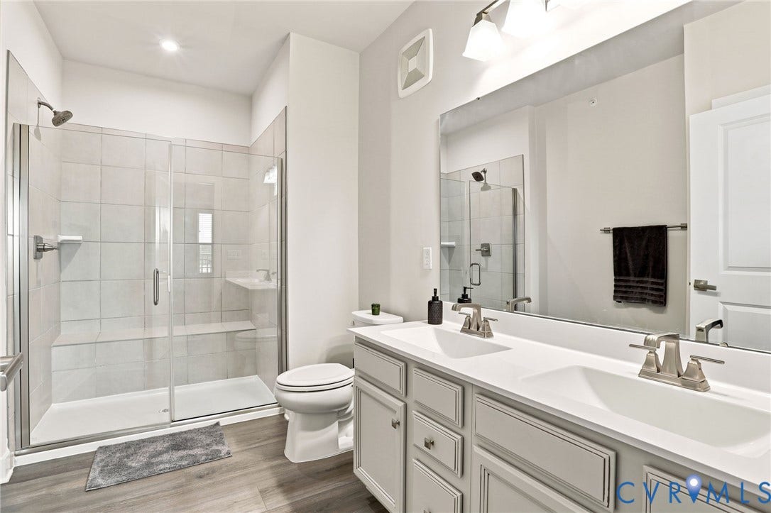 3900 Maze Runner Drive, #403, Midlothian, VA 23112 Dual vanity with integrated sinks, upgraded frameless glass shower door tiled shower walls, and a large mirror