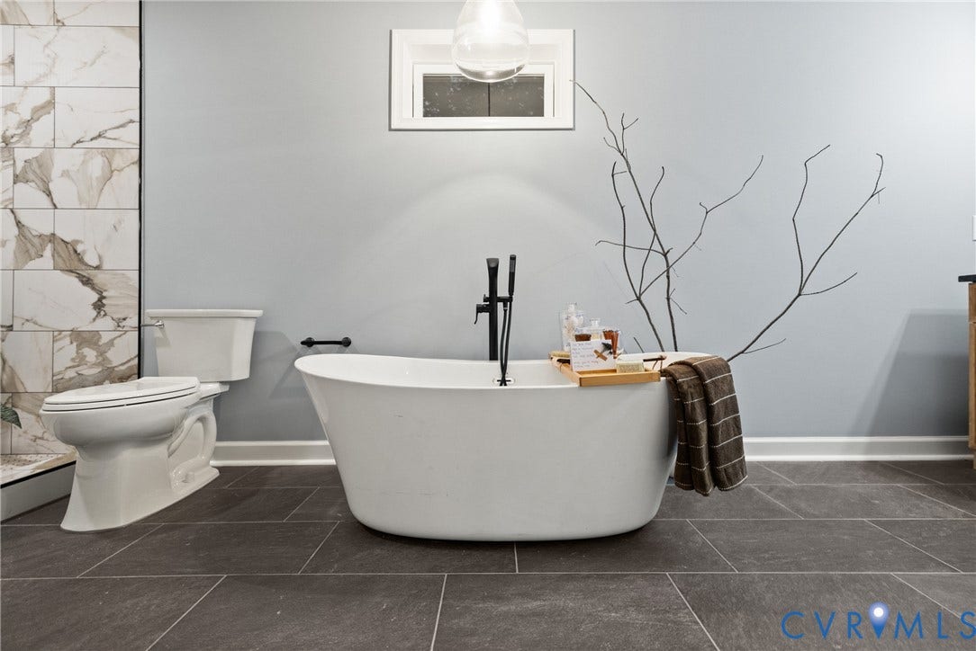 1500 Leicester Road, Cedarhurst - Westover Hills, Richmond, VA 23225 Freestanding soaking tub with a floor-mounted matte black faucet