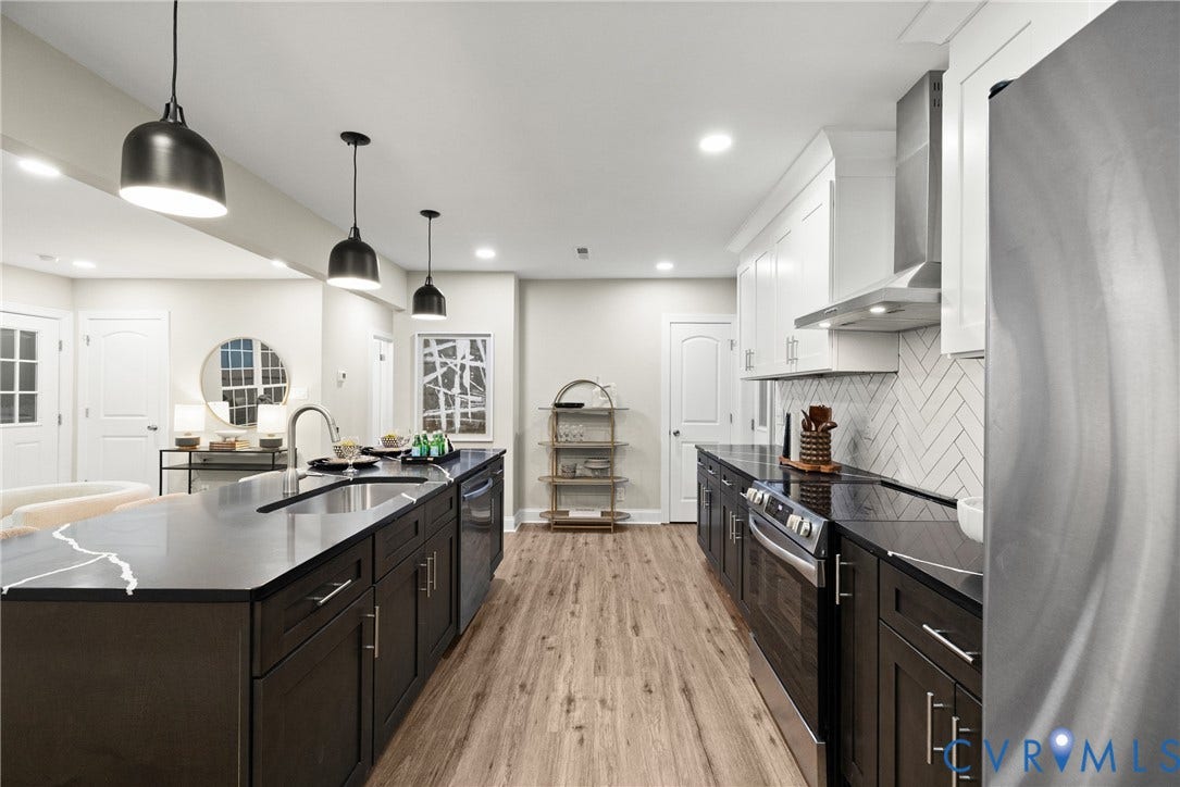 1500 Leicester Road, Cedarhurst - Westover Hills, Richmond, VA 23225 Open-concept kitchen featuring dark cabinetry, dark countertops, wood-finish flooring, and stainless steel appliances