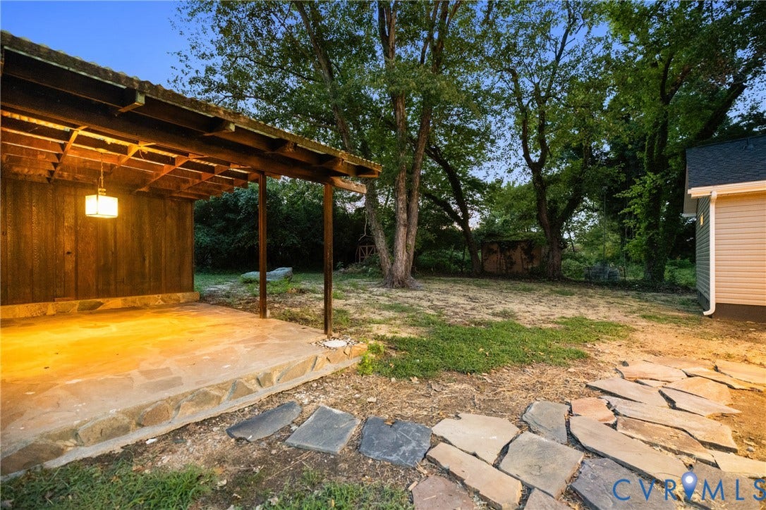 1500 Leicester Road, Cedarhurst - Westover Hills, Richmond, VA 23225 Covered patio with a stone base, overhead lighting, and wood-paneled wall