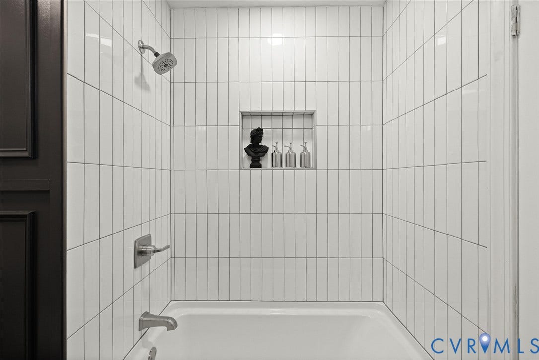 1500 Leicester Road, Cedarhurst - Westover Hills, Richmond, VA 23225 White subway tile shower surround with a built-in niche, chrome showerhead, and bathtub filler