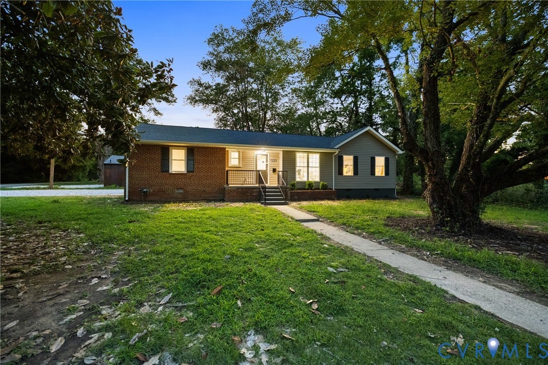 1500 Leicester Road, Cedarhurst - Westover Hills, Richmond, VA 23225 Brick and siding exterior with dark shutters, front porch with dark railing, and established landscaping