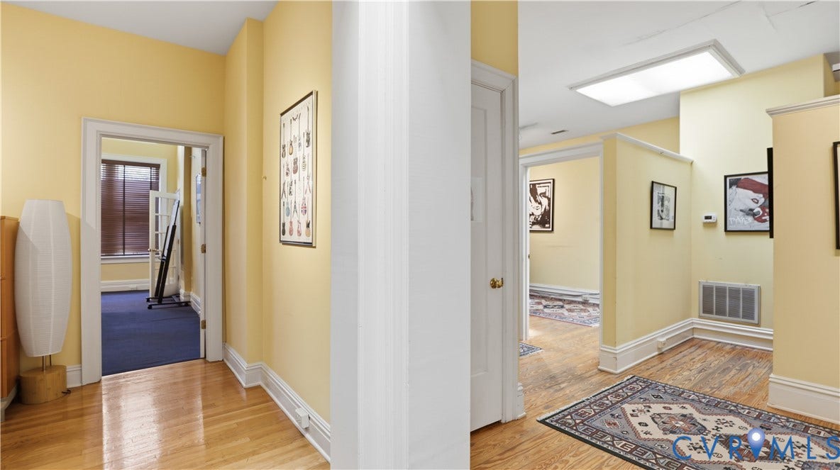 111 N 17th Street, Richmond, VA 23219 Recessed lighting, wood flooring, white trim, and a white door with a brass-finish knob