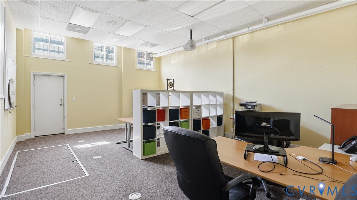 111 N 17th Street, Richmond, VA 23219 Carpeted flooring, high ceilings with ceiling tiles, multiple upper-level windows, and a built-in shelving unit