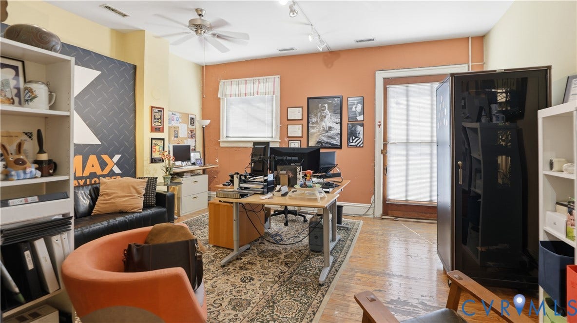 111 N 17th Street, Richmond, VA 23219 Wood-finish flooring, ceiling fan, white trim windows, white shelving units, and a wooden paneled door