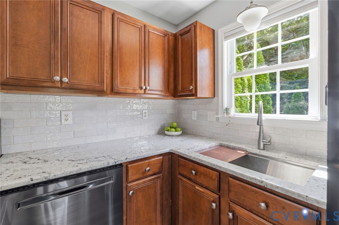 6201 Cameron Bay Terrace, Cameron Bay, Midlothian, VA 23112 Wood-finish cabinetry paired with white subway tile backsplash, light-toned countertops, stainless steel sink with a pull-down faucet, and a large window