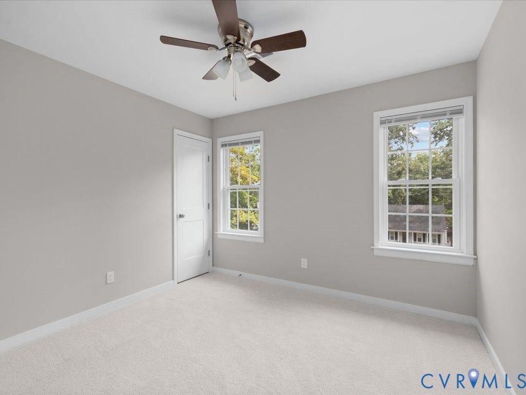 3313 New Found Lane, Chester, VA 23831 Neutral-toned walls, ceiling fan with light kit, two double-hung windows, white trim, and light-colored carpeting