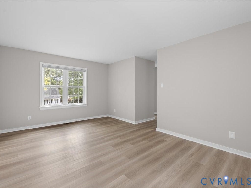 3313 New Found Lane, Chester, VA 23831 Spacious room featuring light wood-finish flooring, neutral gray wall tones, and white trim
