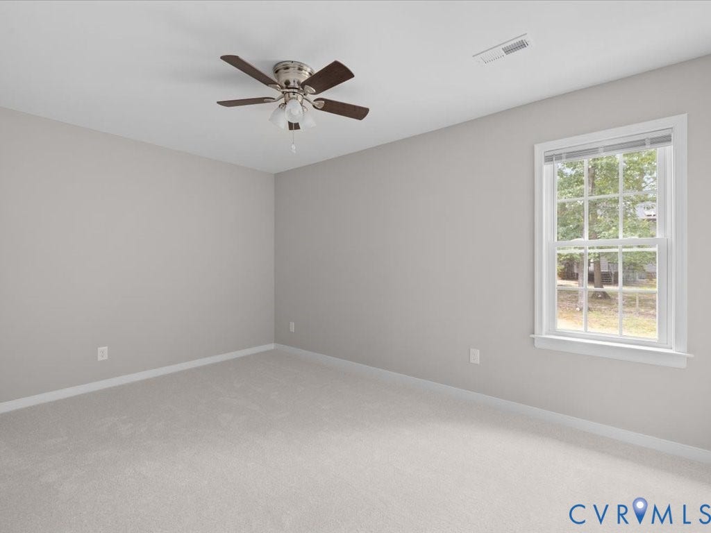 3313 New Found Lane, Chester, VA 23831 Neutral-toned walls with light-colored carpeting, a multi-pane window, and a ceiling fan with integrated lighting