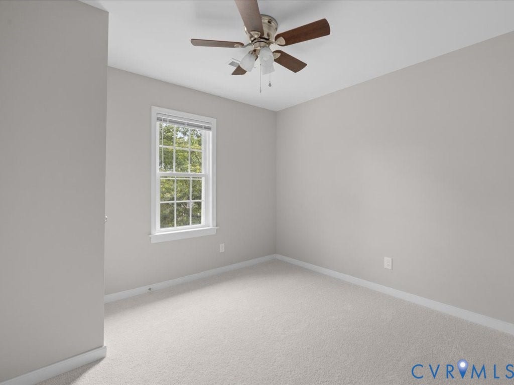3313 New Found Lane, Chester, VA 23831 Neutral wall color, wall-to-wall carpeting, wood-finish ceiling fan with light, and a window with white trim
