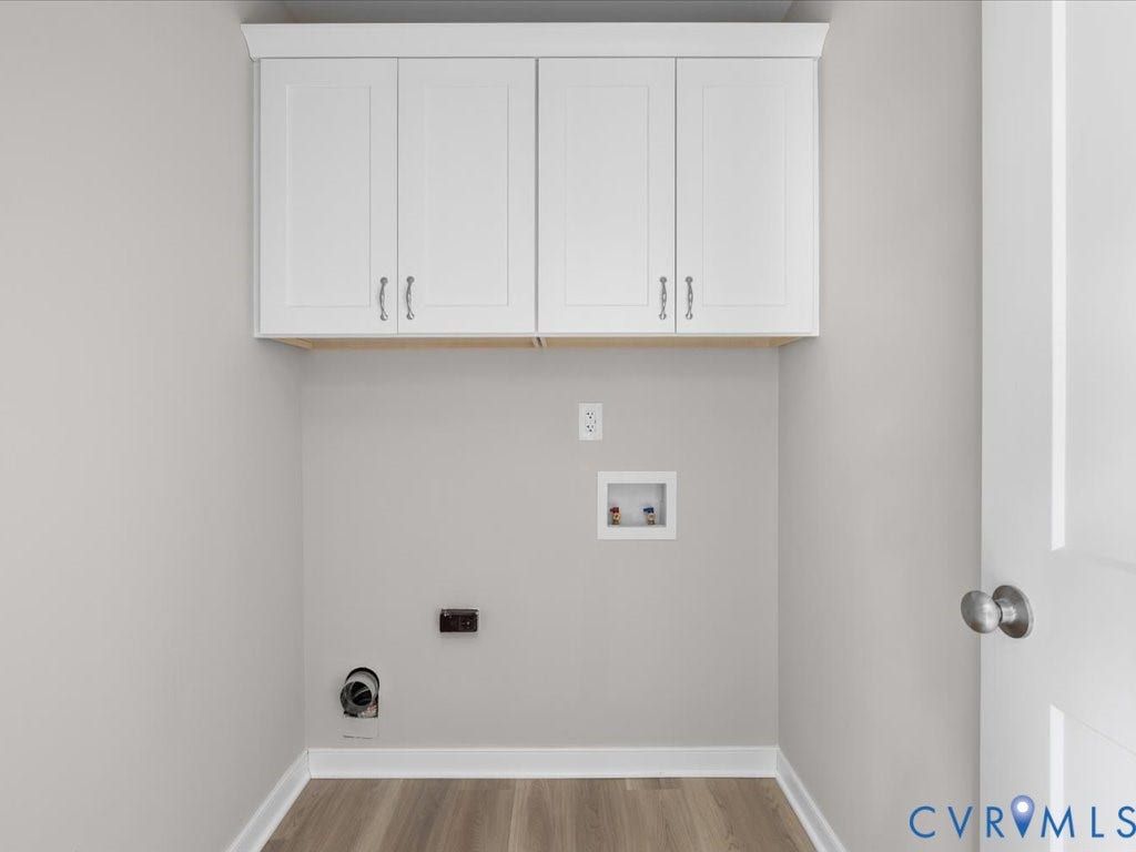 3313 New Found Lane, Chester, VA 23831 White shaker-style cabinetry, wood-finish flooring, light gray wall paint, and a white paneled door with a brushed nickel doorknob