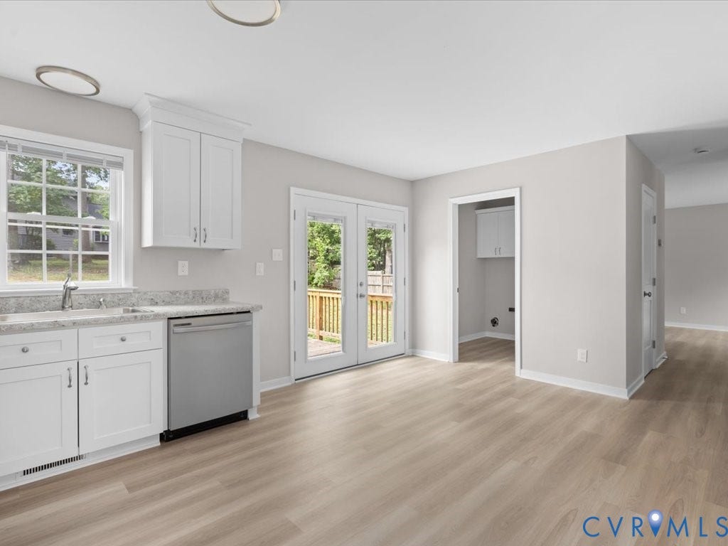 3313 New Found Lane, Chester, VA 23831 White shaker cabinetry, light-toned wood-finish flooring, stainless steel dishwasher, and a double patio door