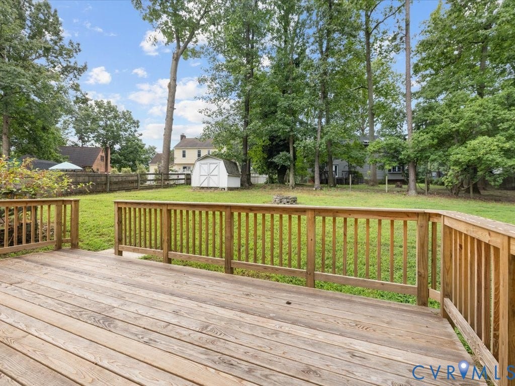 3313 New Found Lane, Chester, VA 23831 Expansive wooden deck with railing, leading to a large grass yard