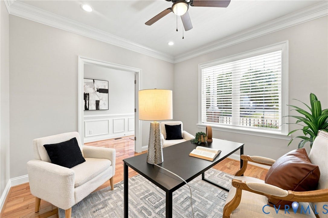 Dedicated first-floor office with hardwood floors, crown molding, recessed lighting, and plenty of natural light.