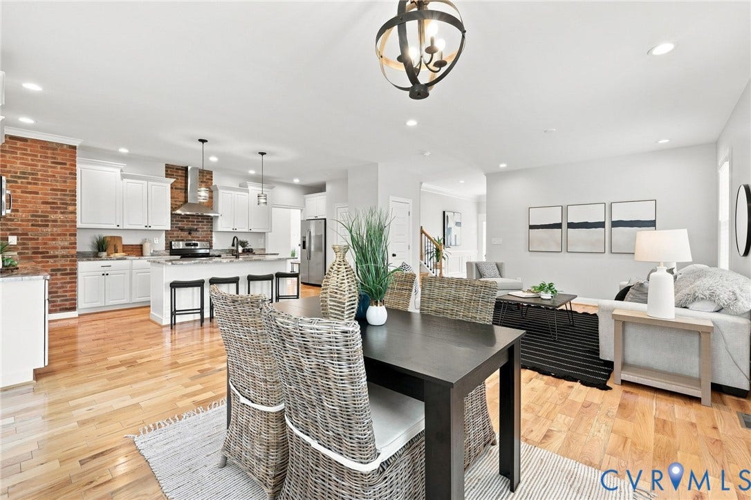 The dining area flows seamlessly into the kitchen and family room, creating a spacious layout ideal for entertaining.