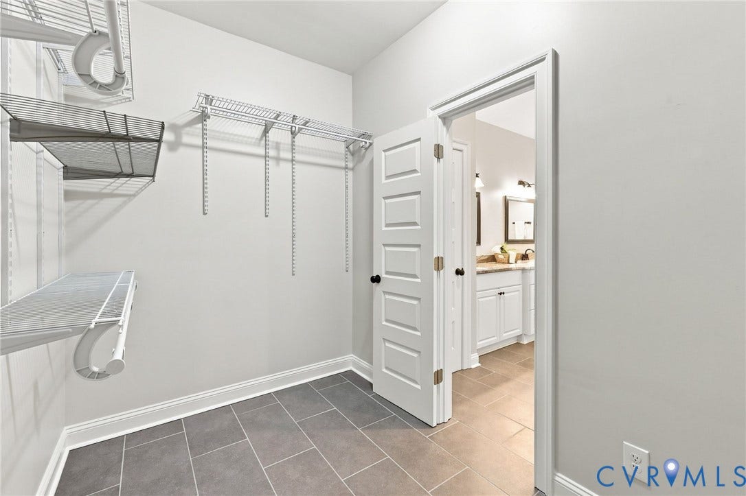 One of TWO generous walk-in closets provides plenty of shelving and storage space.