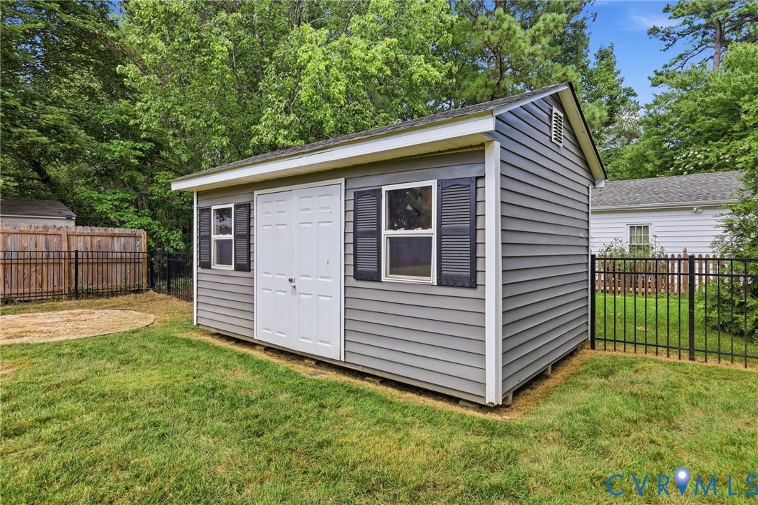 Detached storage shed provides convenient additional space for lawn equipment, tools, and outdoor gear.