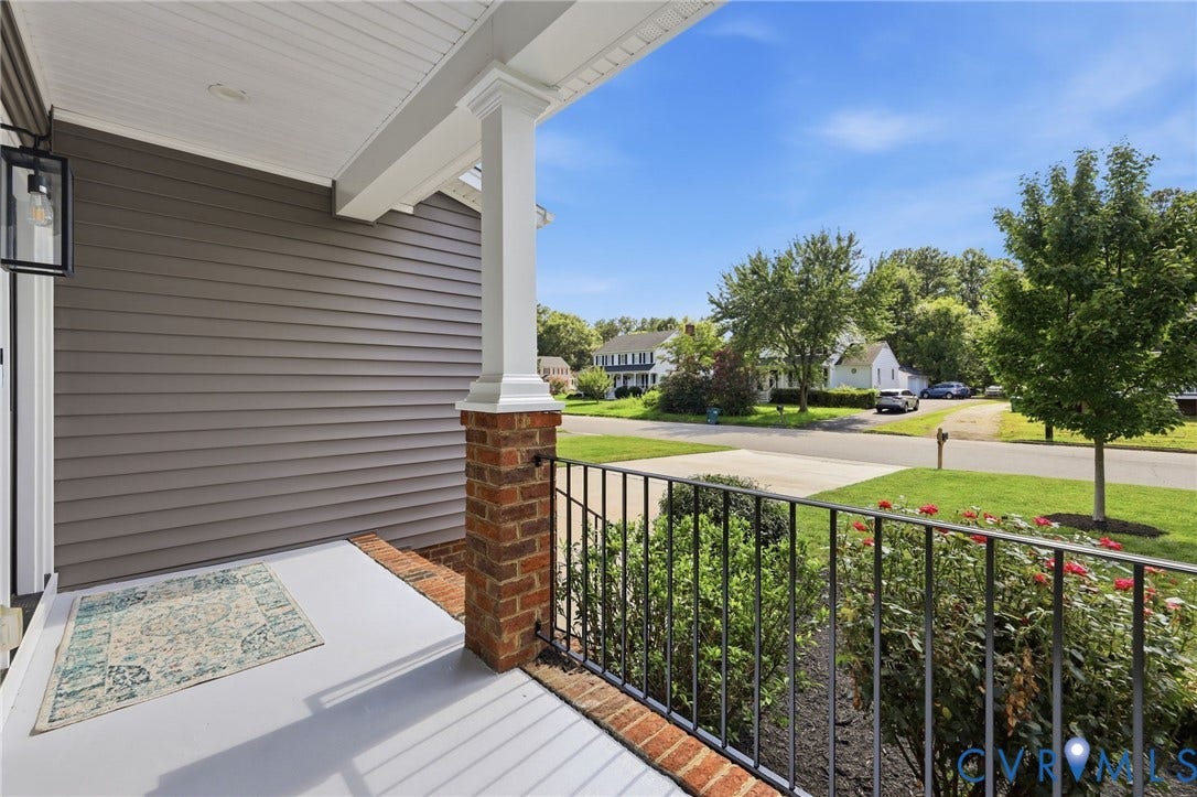Enjoy a charming covered front porch overlooking the beautifully maintained front yard.
