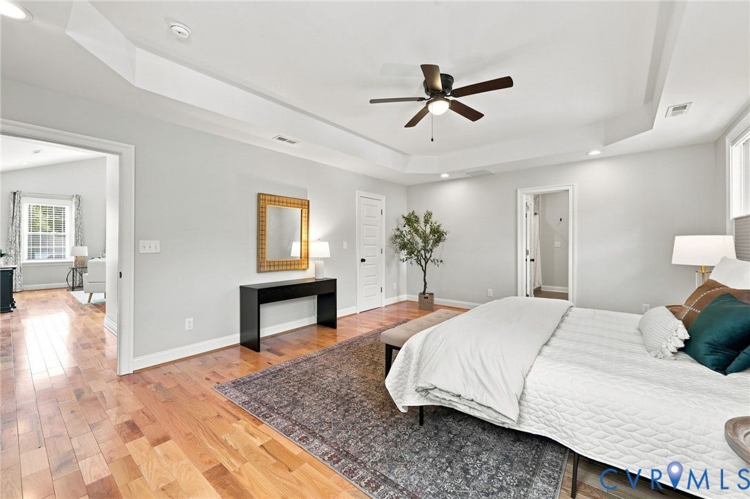 Another view highlighting the generous size of the primary suite and its private en-suite bath.