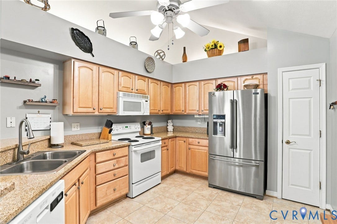 7230 Norwood Pond Court, Midlothian, VA 23112 Kitchen featuring wood-finish cabinetry, stainless steel refrigerator, white range, built-in microwave, and a double basin sink