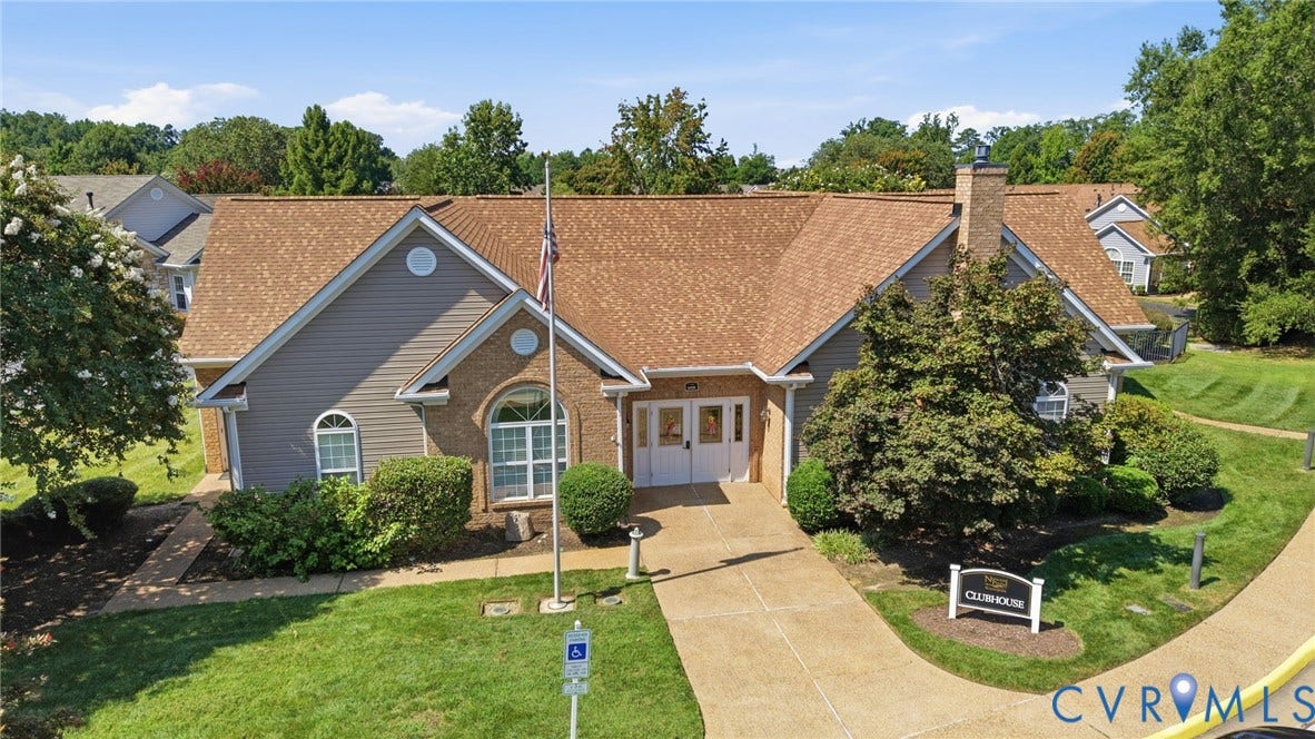 7230 Norwood Pond Court, Midlothian, VA 23112 Clubhouse with brick and siding exterior, arched windows, dual entry doors, and a concrete pathway