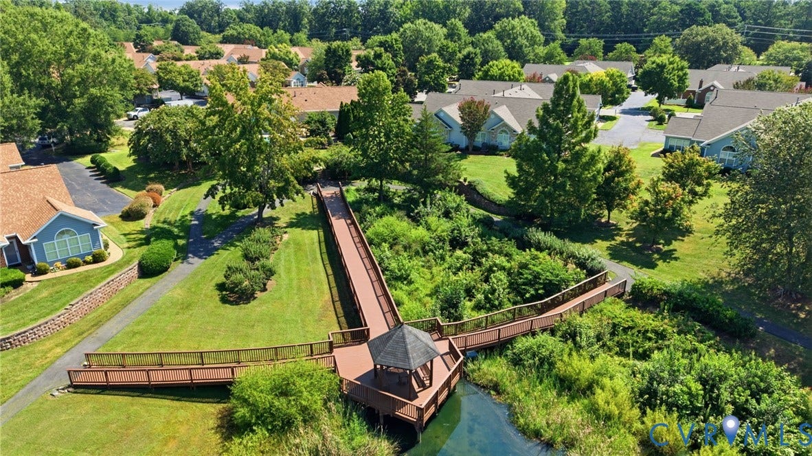 7230 Norwood Pond Court, Midlothian, VA 23112 Wood-finish walkway with integrated gazebo, surrounded by mature trees and residential structures