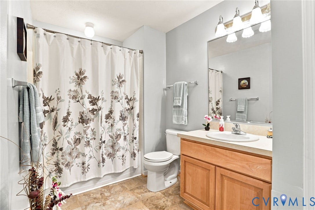 7230 Norwood Pond Court, Midlothian, VA 23112 Light-toned flooring, wood-finish vanity with countertop, and integrated sink