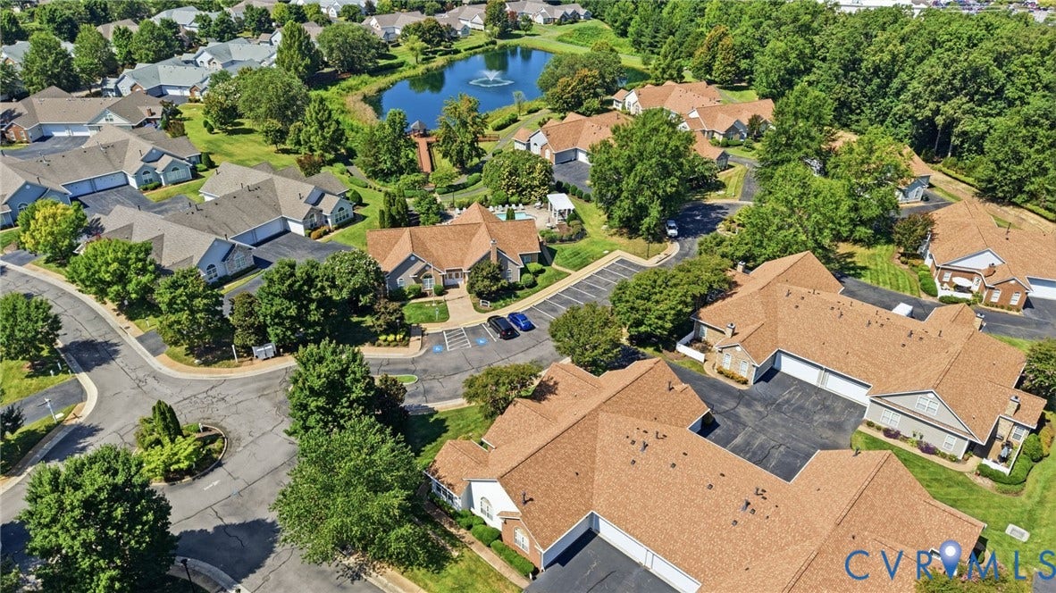 7230 Norwood Pond Court, Midlothian, VA 23112 Community featuring multiple residential structures, a central pond with a water feature, and extensive mature landscaping