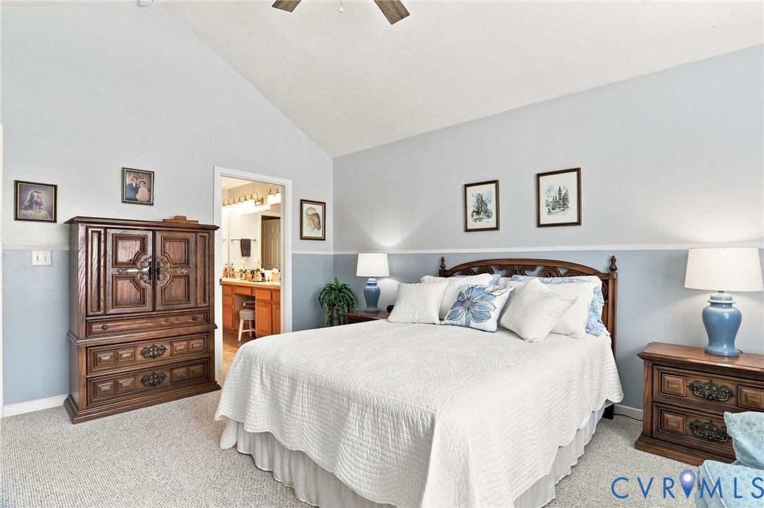 7230 Norwood Pond Court, Midlothian, VA 23112 Vaulted ceiling with a ceiling fan, carpeted flooring, and a doorway to an additional room