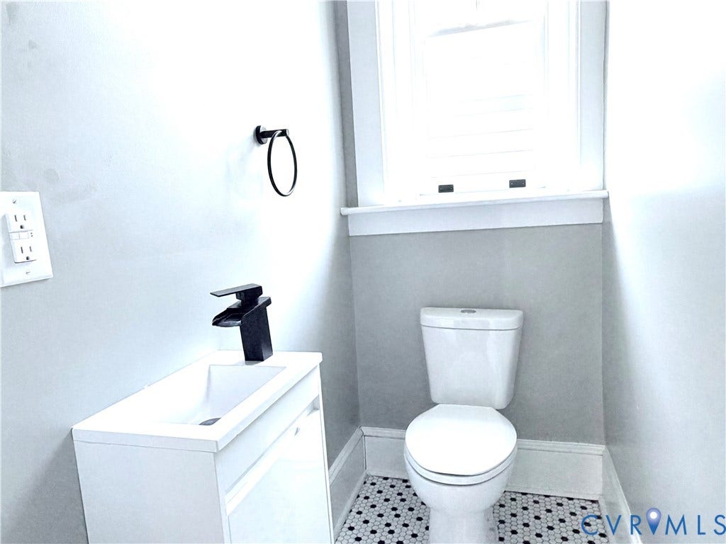 3614 Carolina Avenue, Richmond, VA 23222 Compact bathroom with white vanity, matte black faucet, and hexagon tile flooring