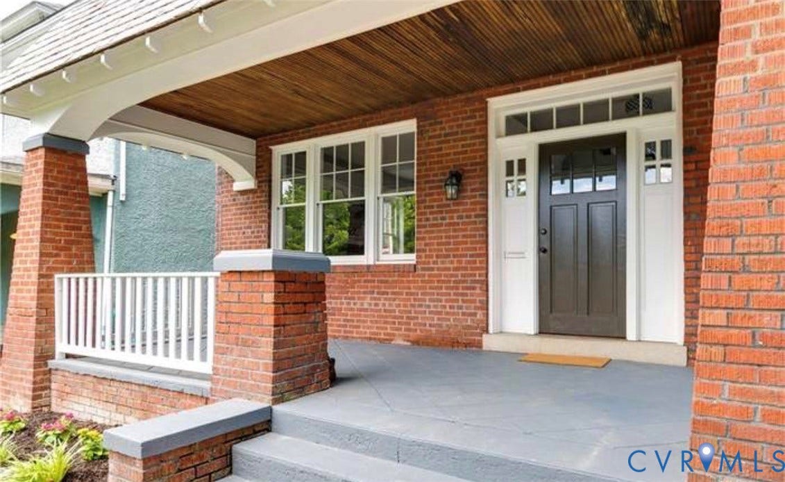 3614 Carolina Avenue, Richmond, VA 23222 Brick exterior with a covered front porch, wood-finish porch ceiling, multi-pane windows, and a panel-style front door with transom and sidelights
