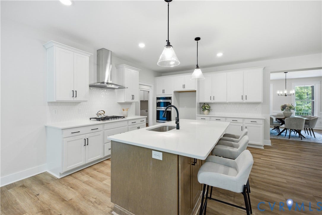 3120 Lake Stone (lot 22) Terrace, Maple Grove, Powhatan, VA 23139 Large island with cabinets on both sides, view to dining room. Photo of for-sale home, staged