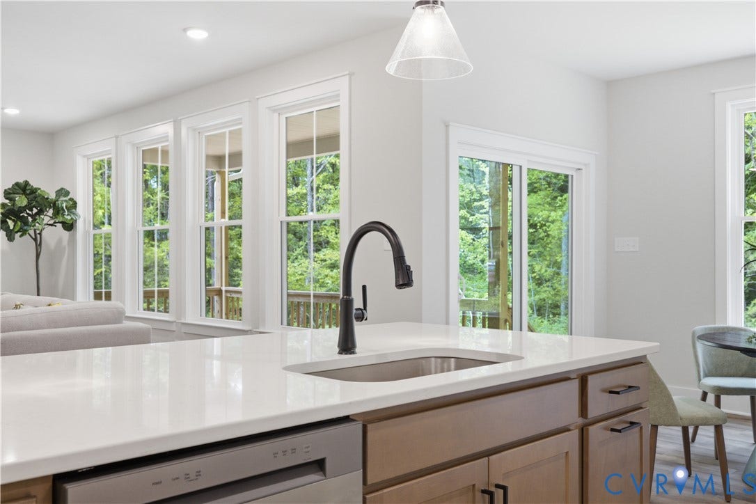 3120 Lake Stone (lot 22) Terrace, Maple Grove, Powhatan, VA 23139 View to family room, dinette and back yard. Photo of for-sale home, staged